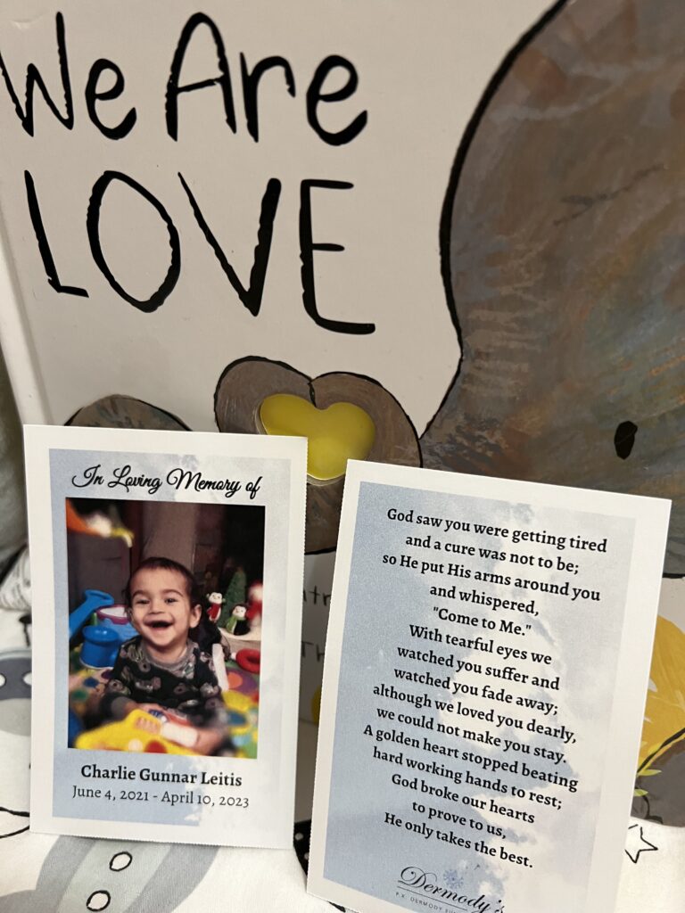 The book we are love propped up with memorial cards for Charlie and the poem at the bottom of this blog